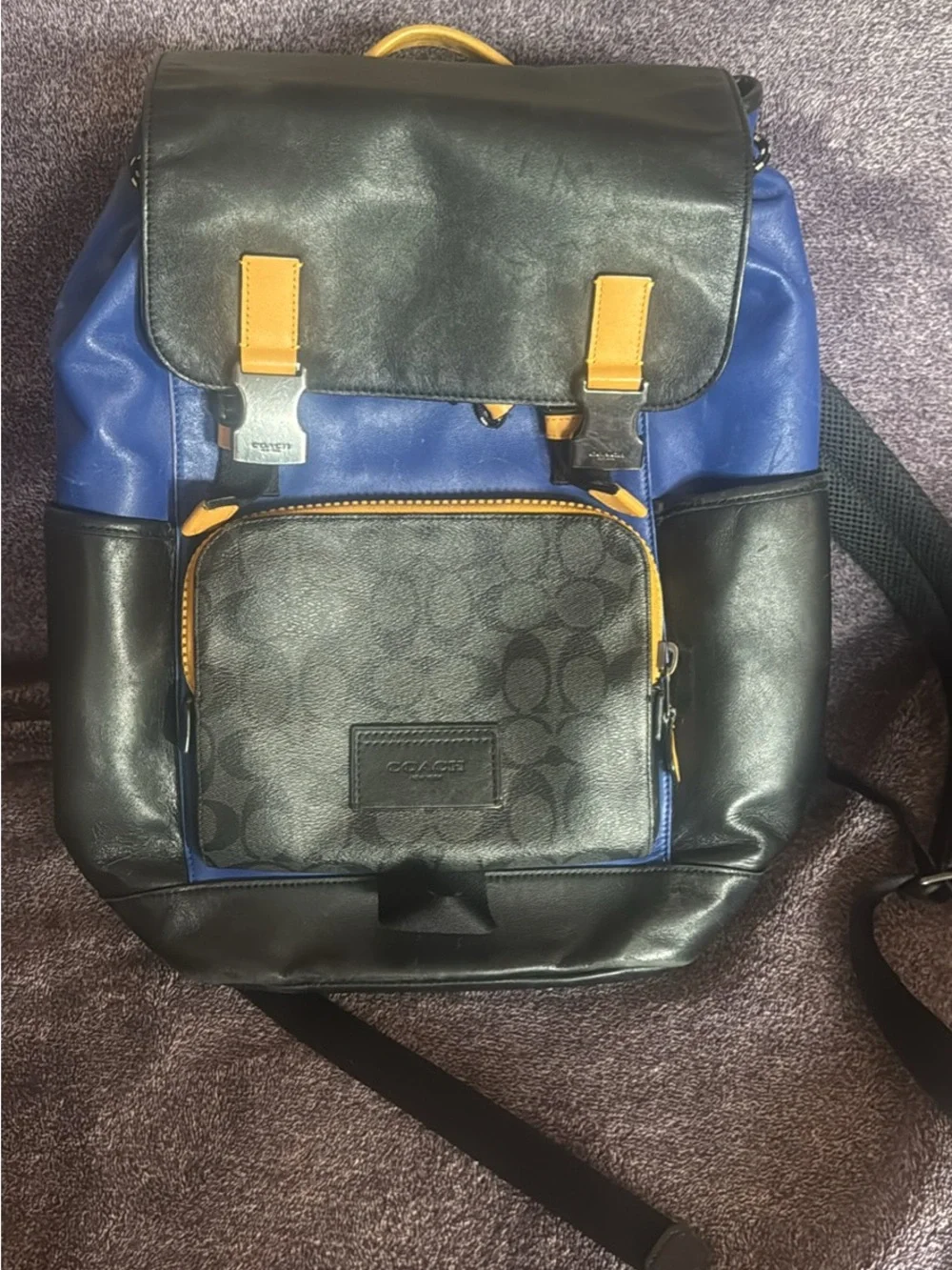 Coach Men's Blue and Black Logo Panel Flap Backpack with Gold Accents